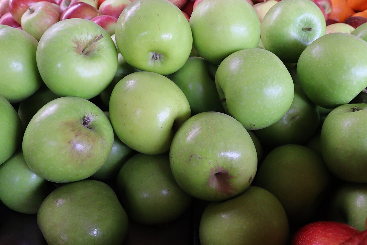 Green and red apples arranged together.