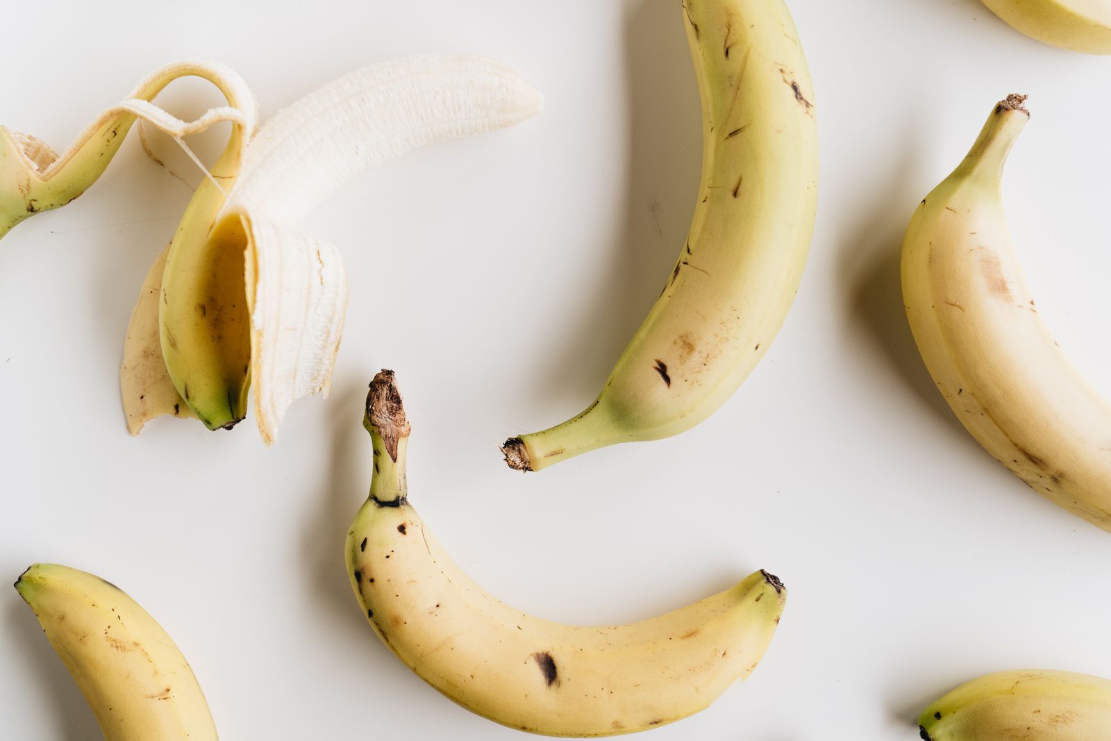 Ripe bananas on a white background
