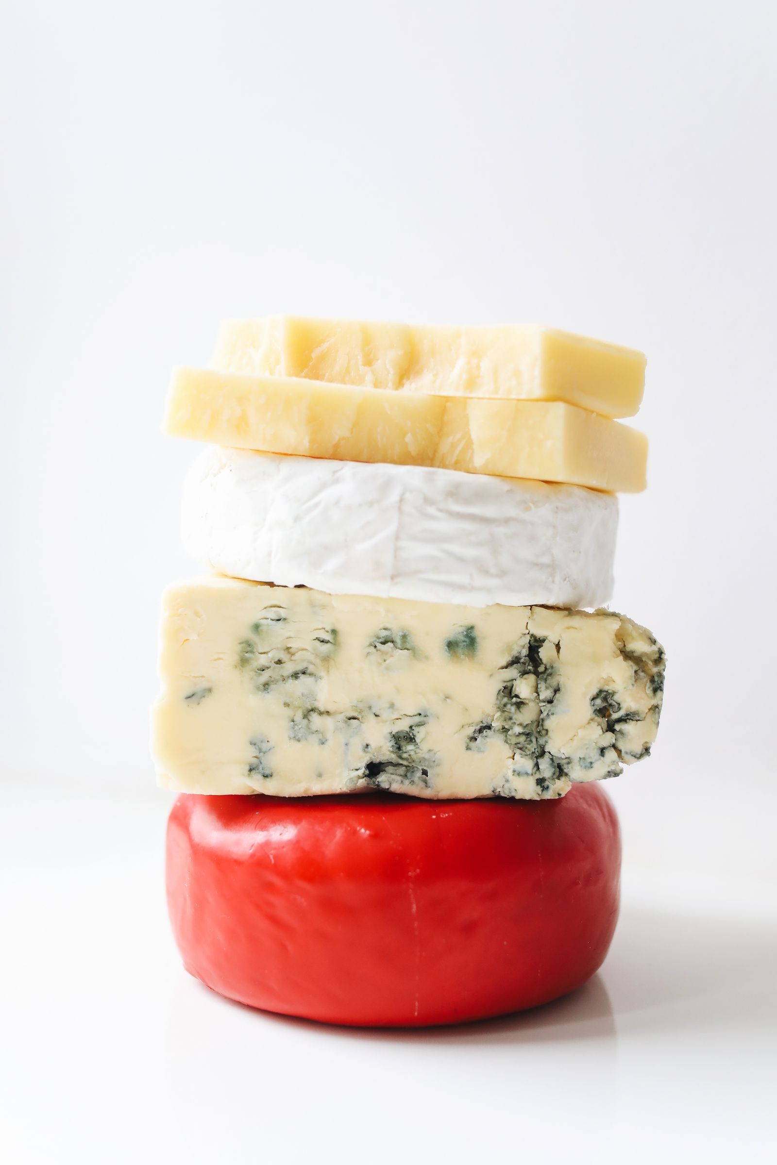 Assorted cheeses on a white background