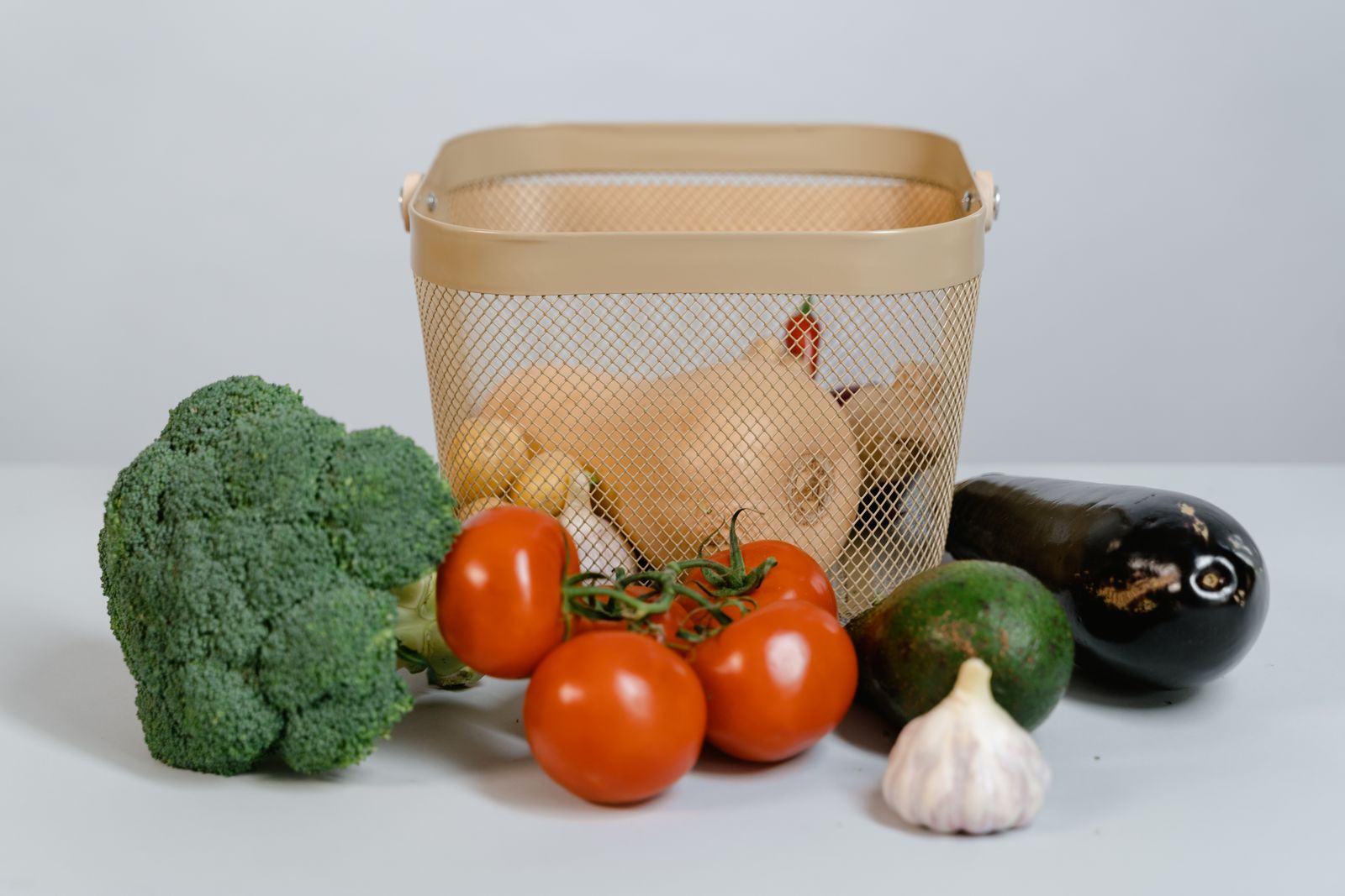 Assorted fresh fruits and vegetables on a white surface