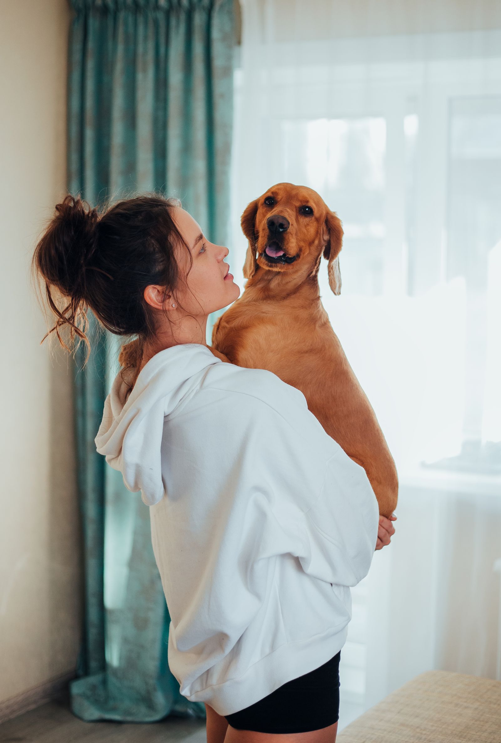 Woman spending time with a dog indoors